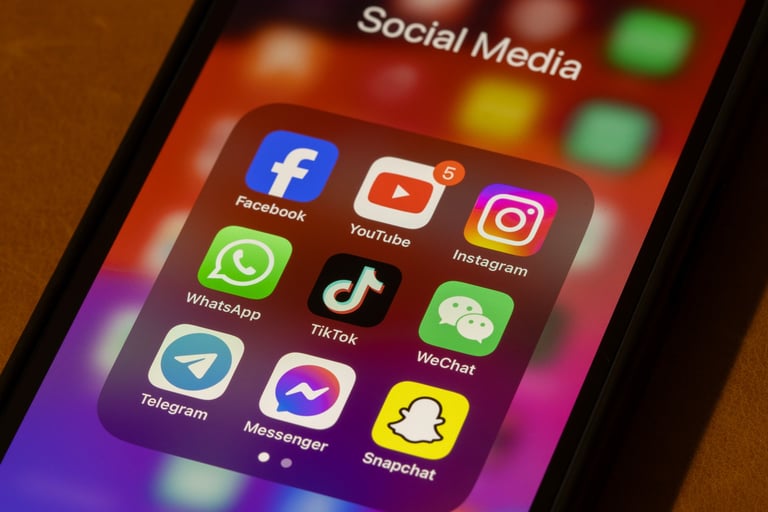 Portland, OR, USA - Nov 11, 2024: Some of the most popular social media apps by number of monthly active users, including Facebook, YouTube, Instagram, WhatsApp, TikTok, WeChat, Telegram, Messenger, and Snapchat, are seen on an iPhone.
